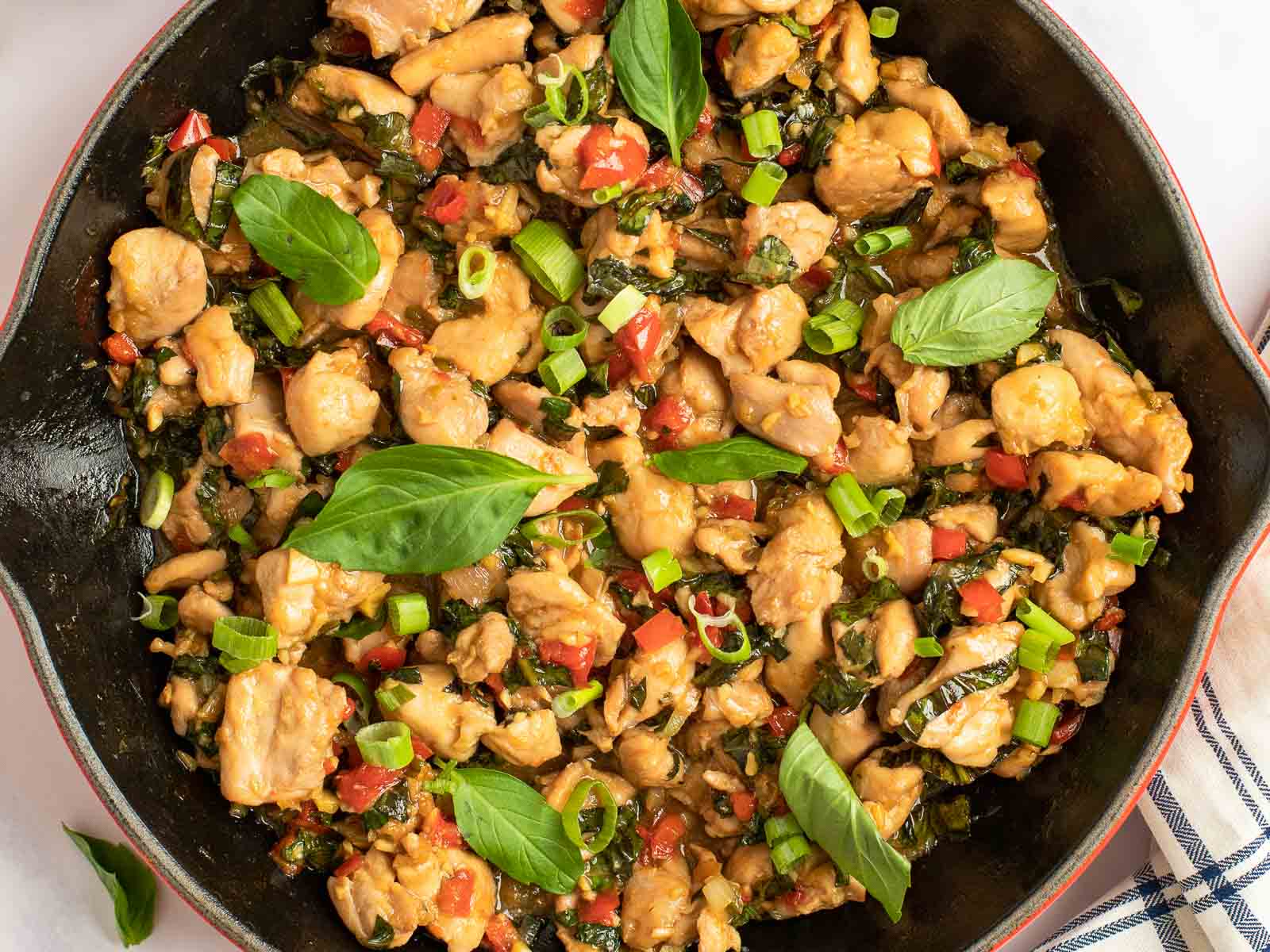 closeup overhead shot of flavorful keto thai basil chicken in a skillet