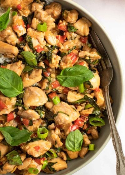 big bowl of thai basil chicken with a fork