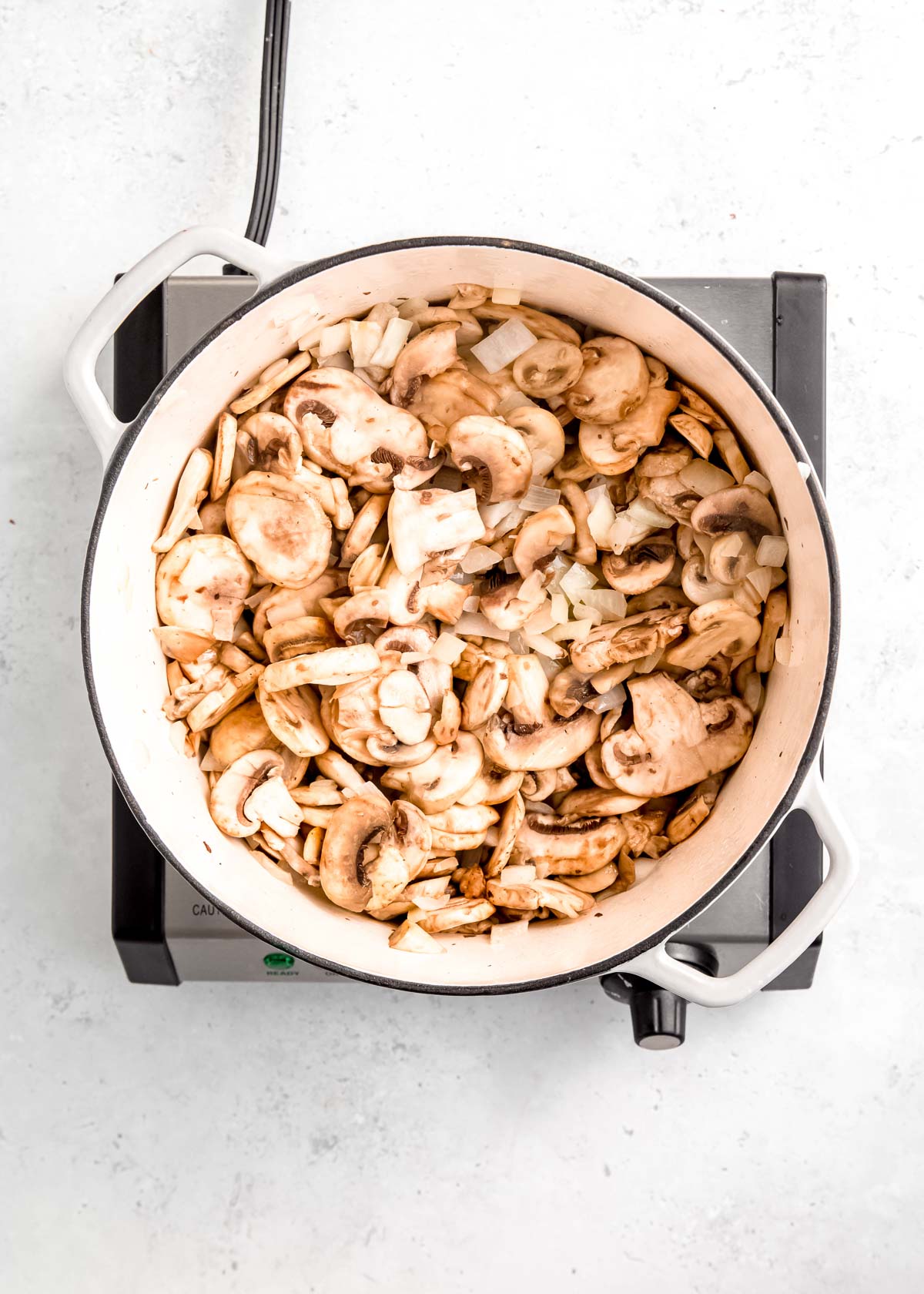 sauteed onions and mushrooms in a pot
