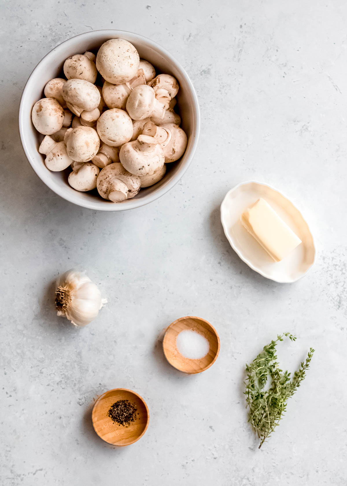 garlic butter mushroom ingredients on a white table