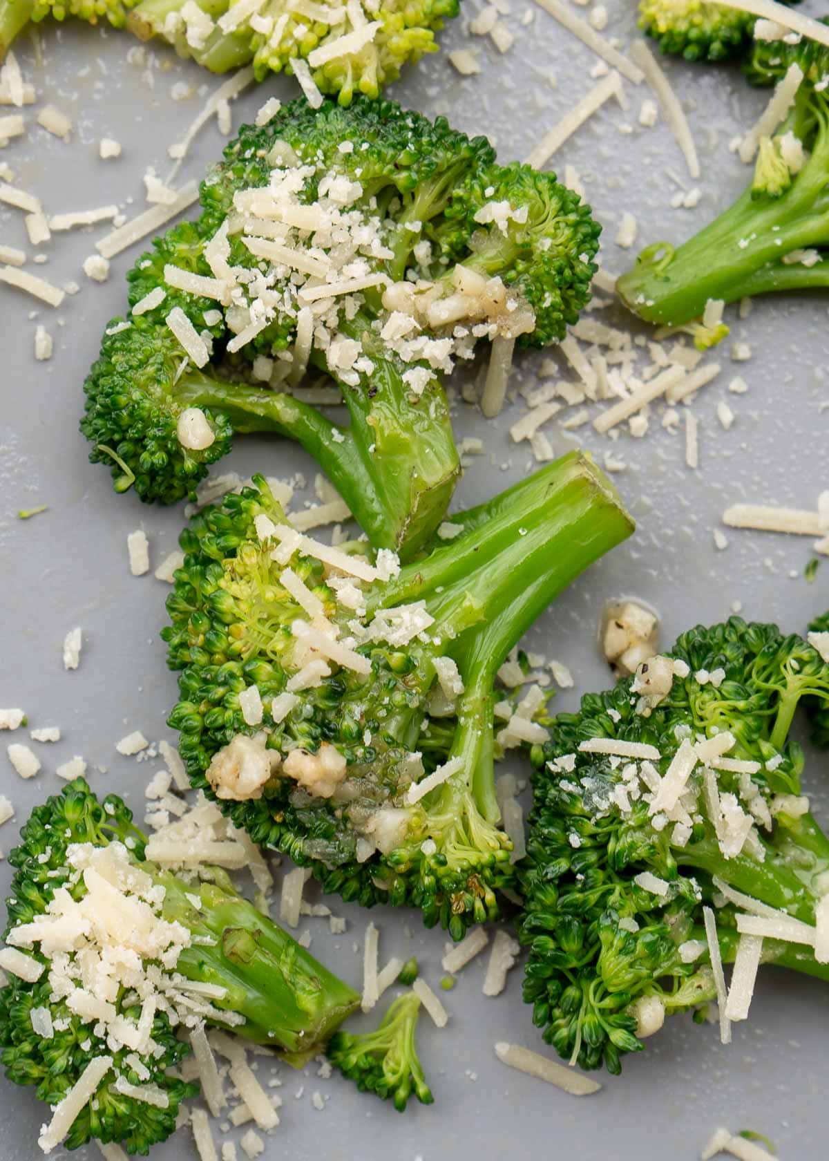 smashed and steamed broccoli covered with parmesan cheese