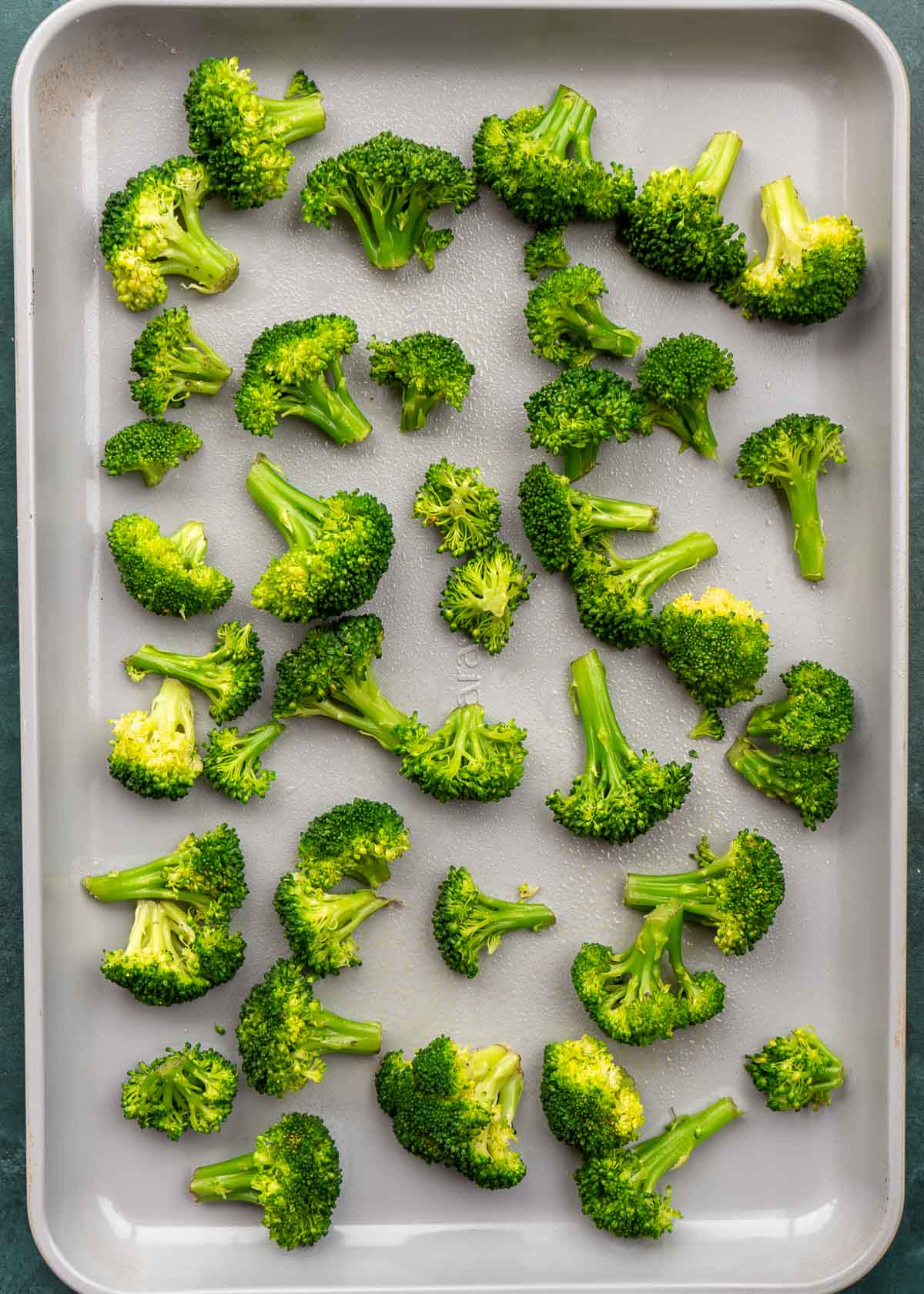 steamed broccoli on a baking pan