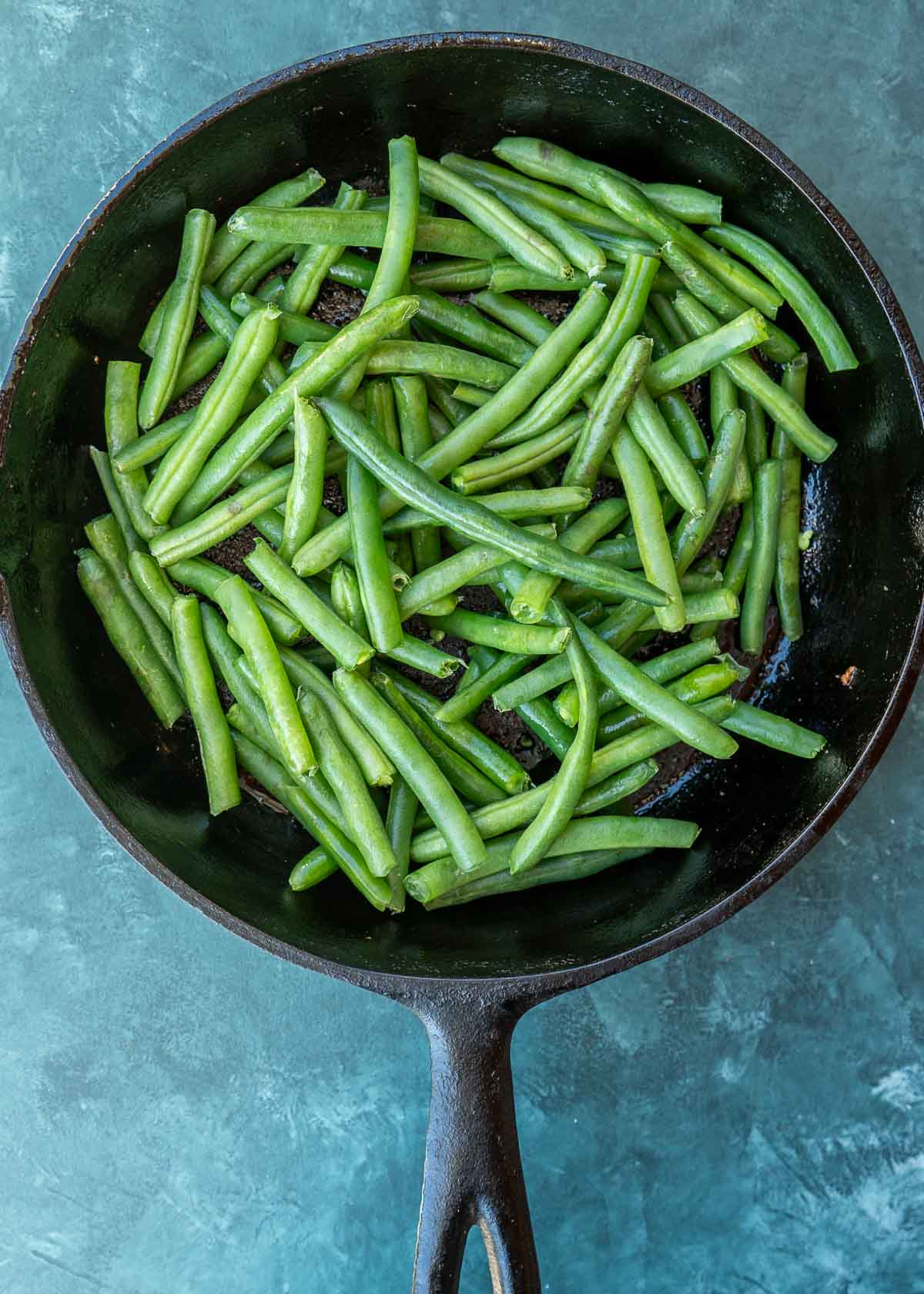 fresh green beans in a cast iron skillet