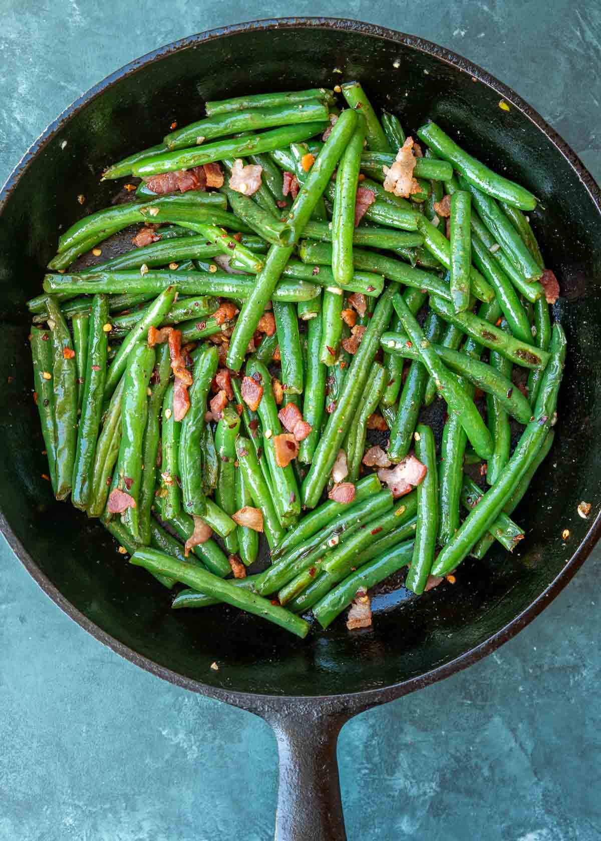 bacon added to green bean recipe in cast iron skillet