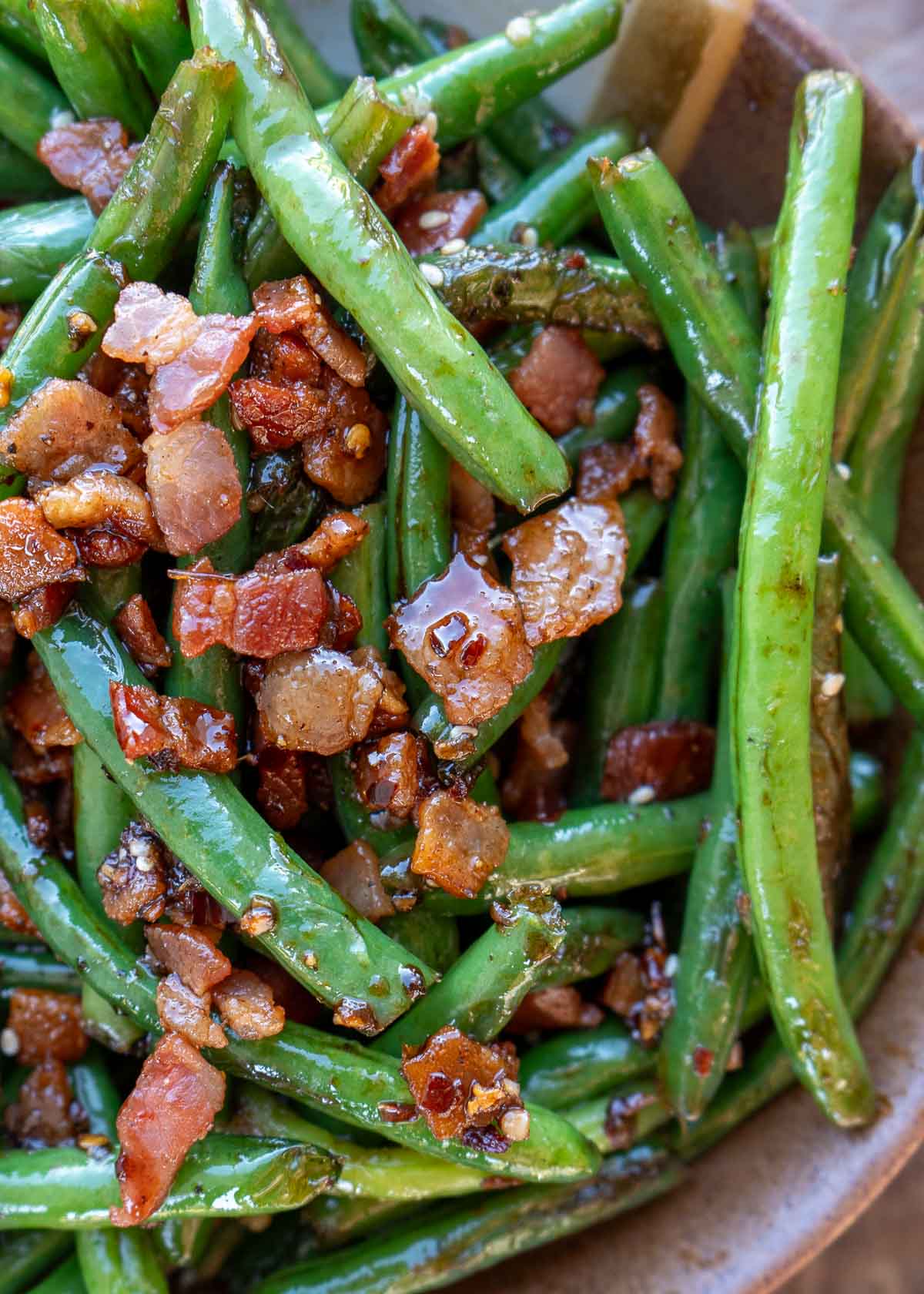 keto green beans and bacon in a bowl, tossed in a sweet and spicy sauce