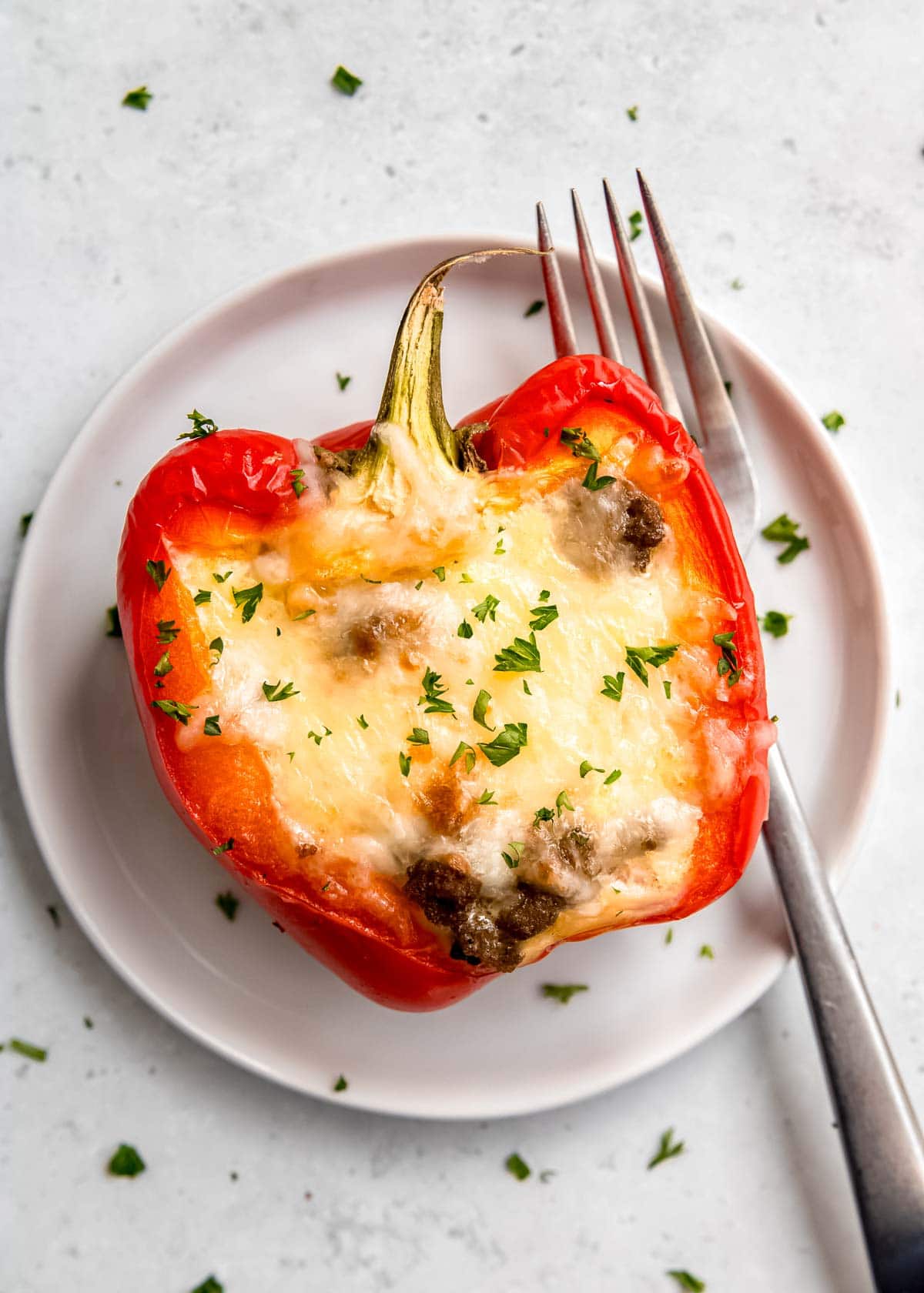 breakfast stuffed bell pepper on white plate with fork