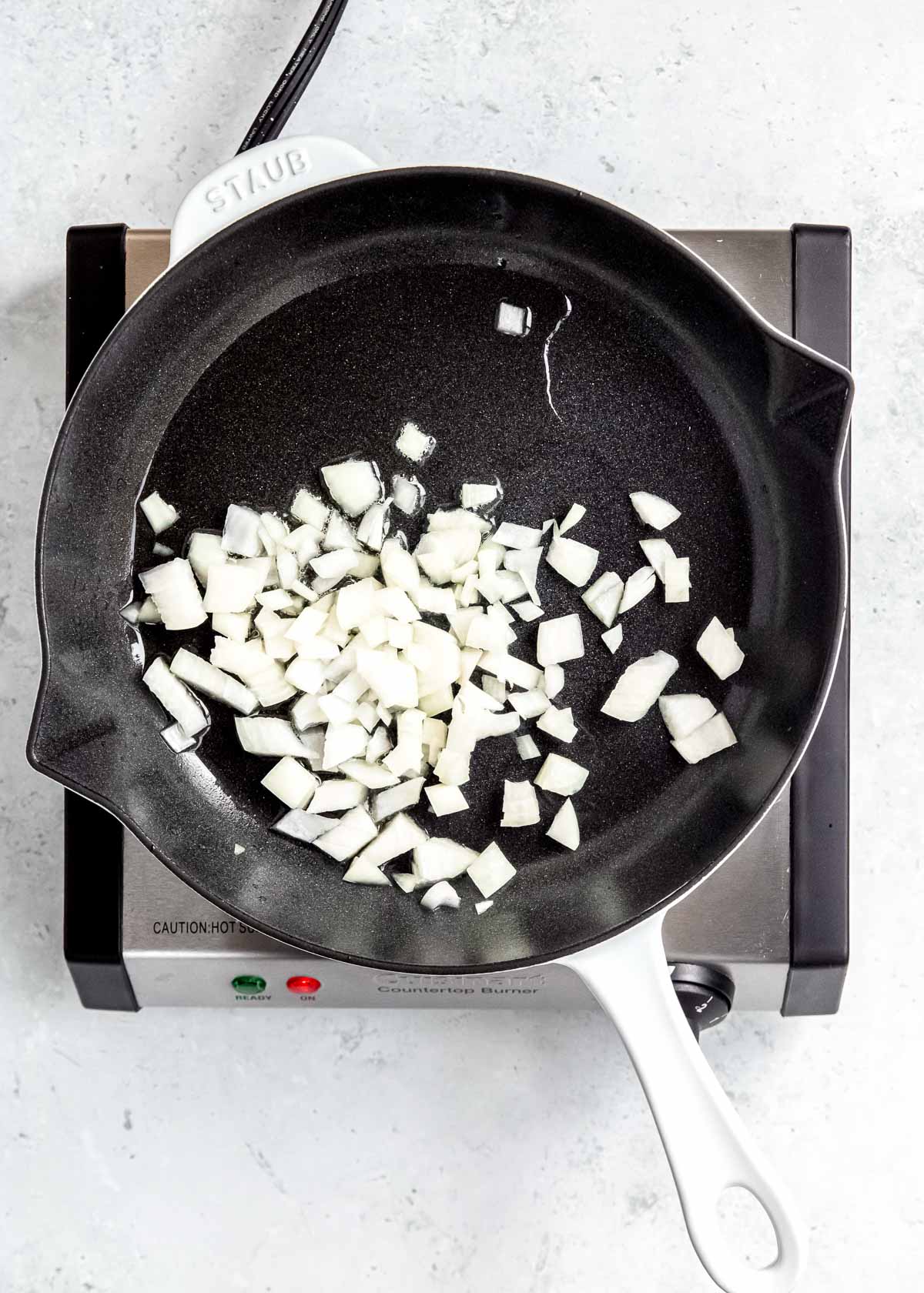 onions being sautéed in black skillet