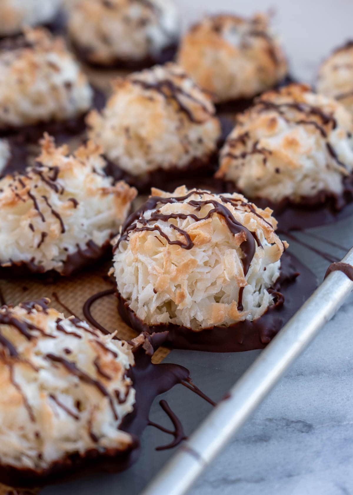 a pan of coconut macaroons drizzled in dark chocolate