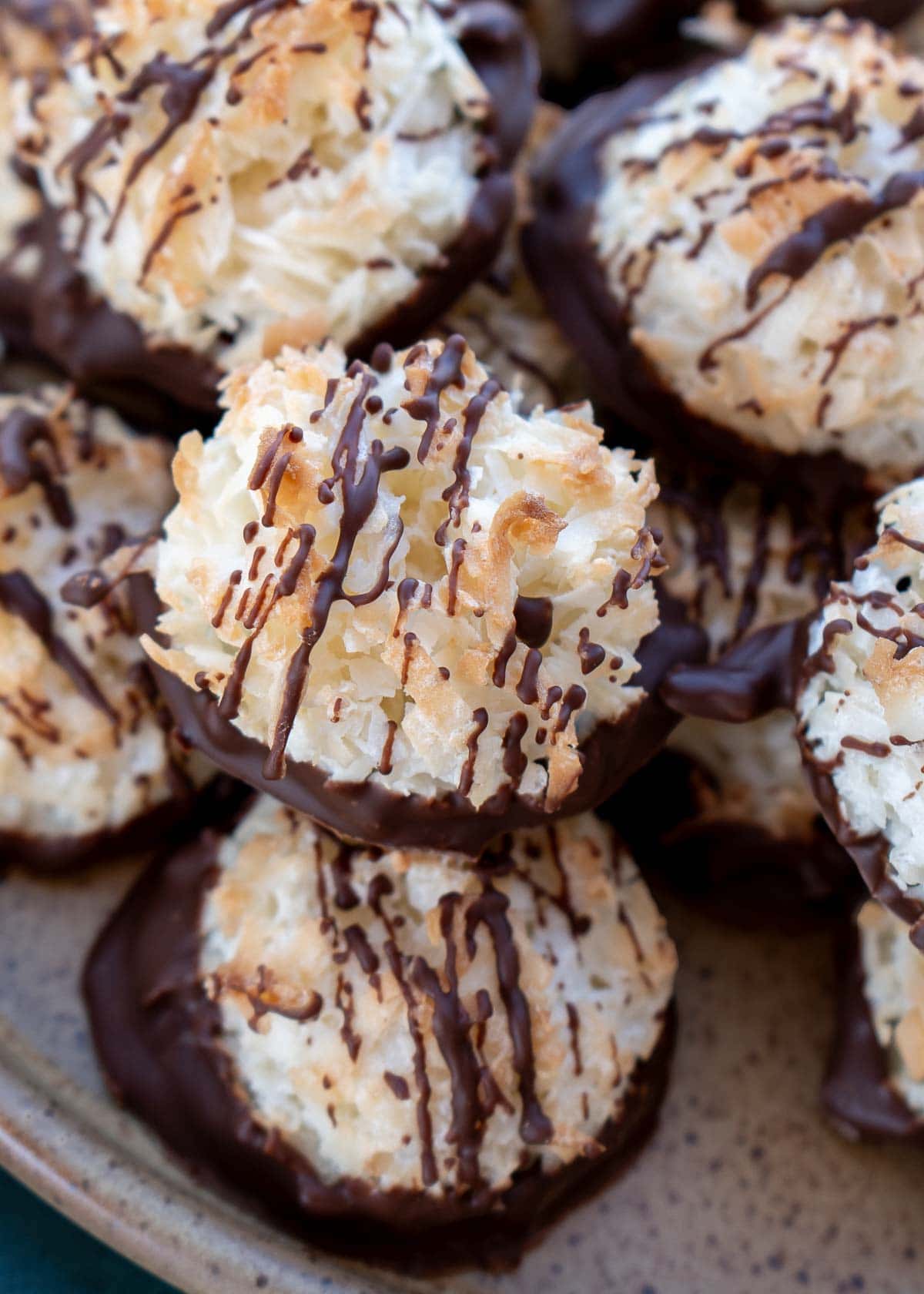 a close up shot of coconut macaroons with dark chocolate