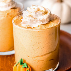 cup of pumpkin mousse topped with whipped cream and cinnamon