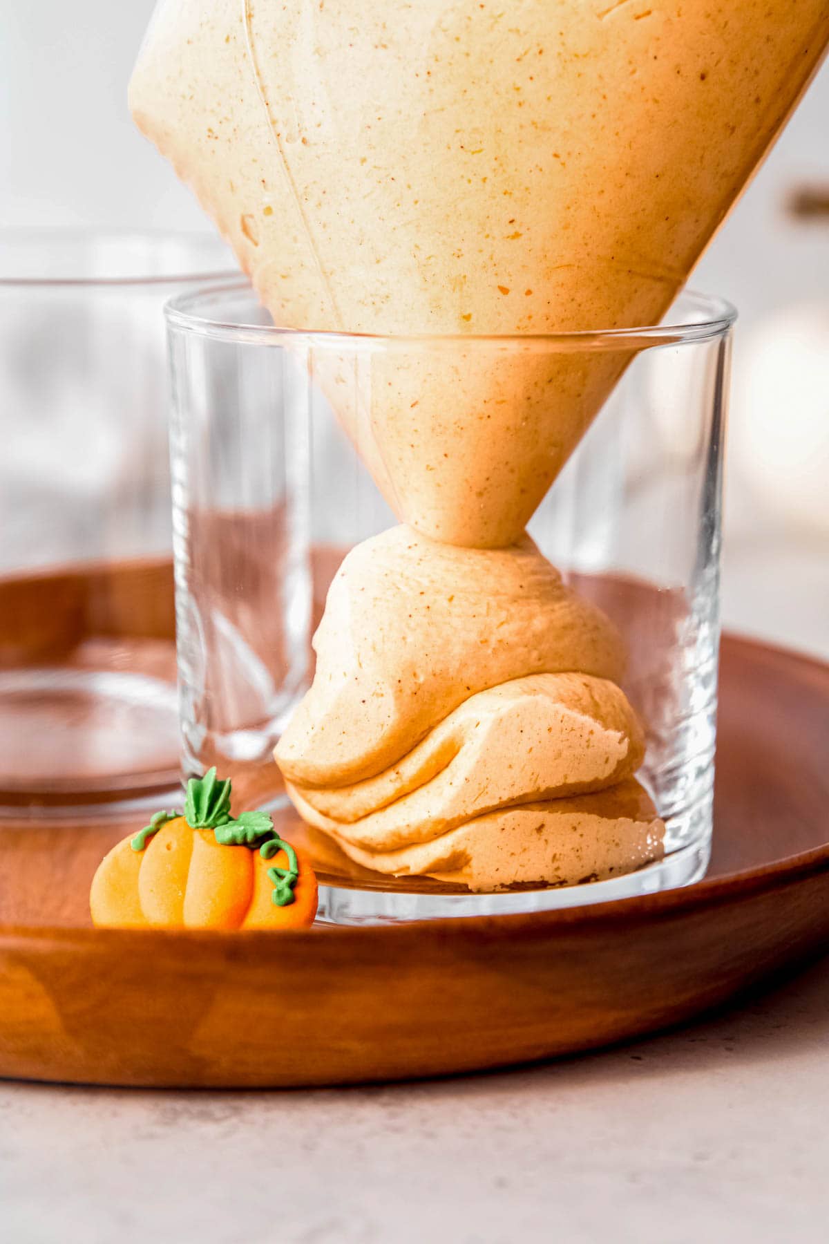 a bag of pumpkin mousse being piped into a glass jar