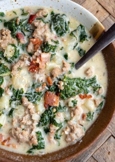an overhead shot of zuppa toscana in a bowl with a spoon