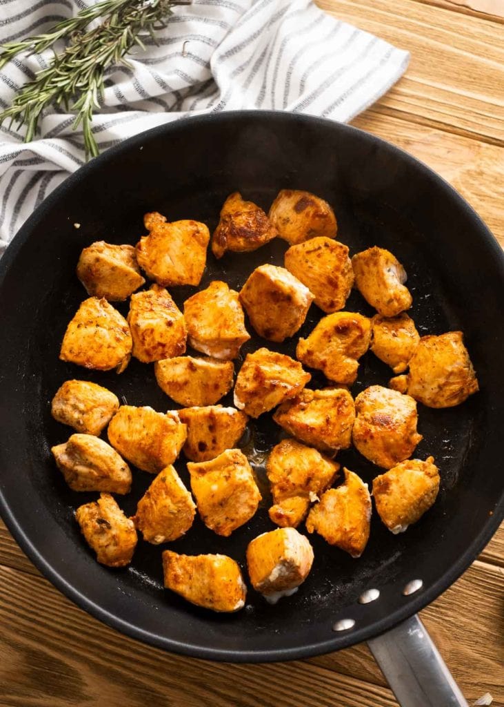 browned chicken bites in a cast iron skillet