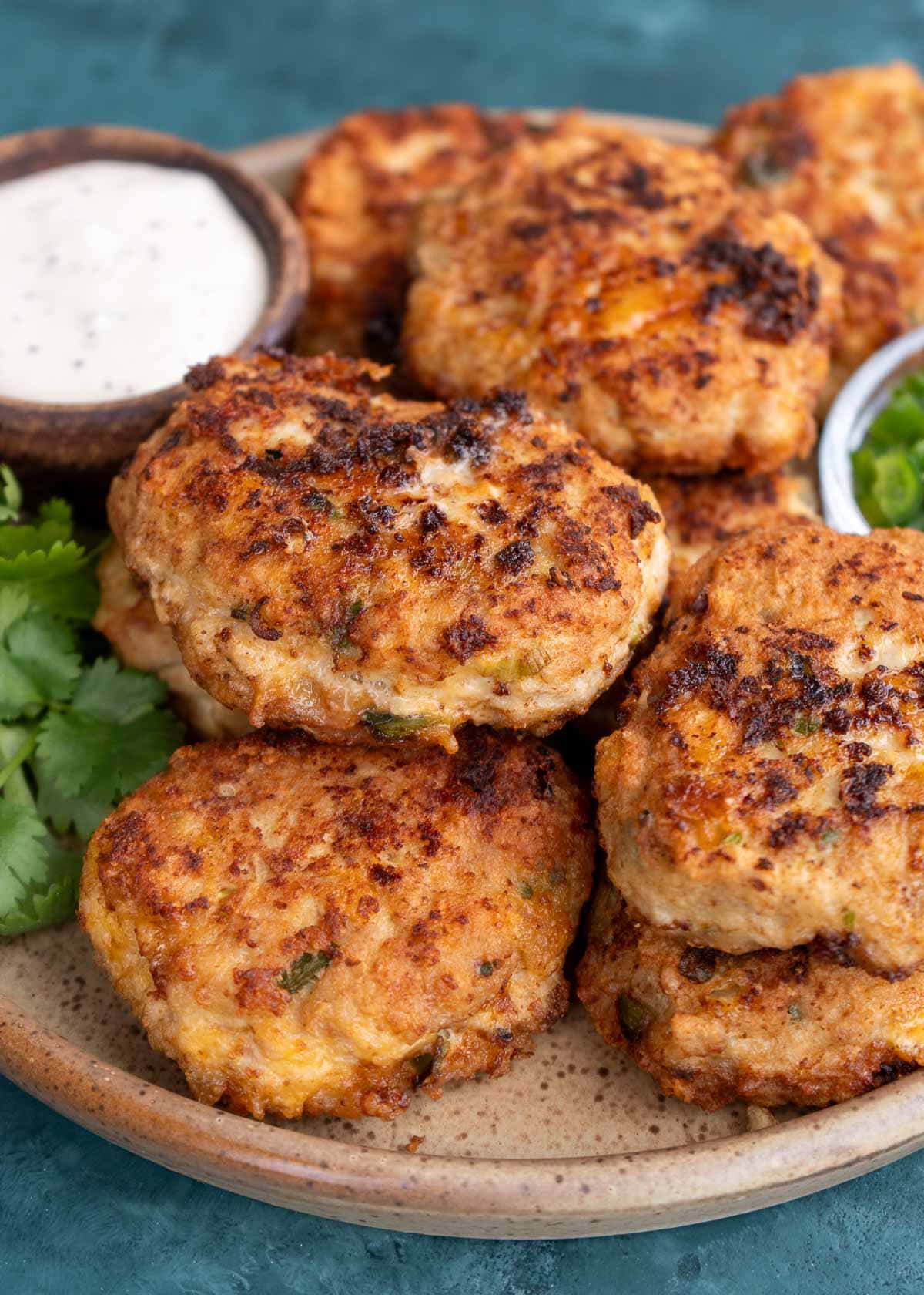 a side angle of a serving plate of chicken fritters