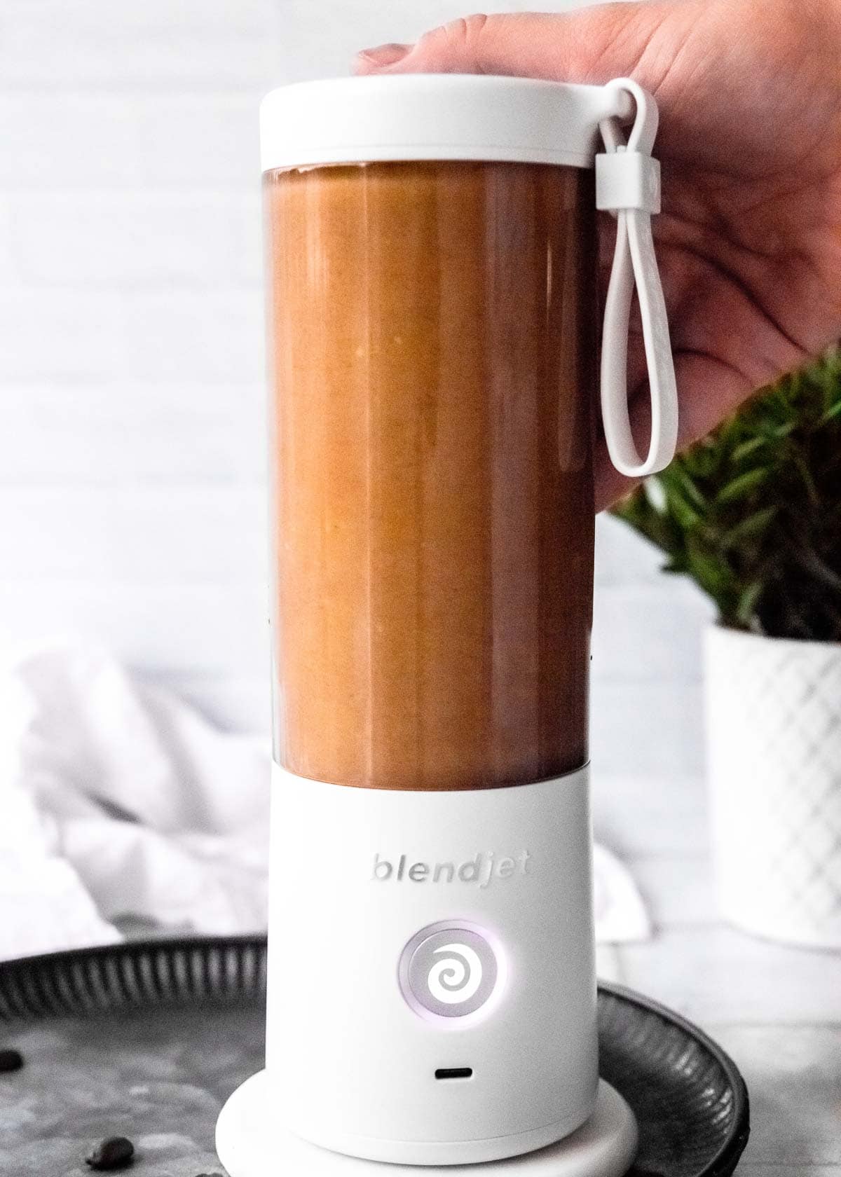 keto smoothie made of coffee, avocado, coconut milk, and peanut butter in a blender