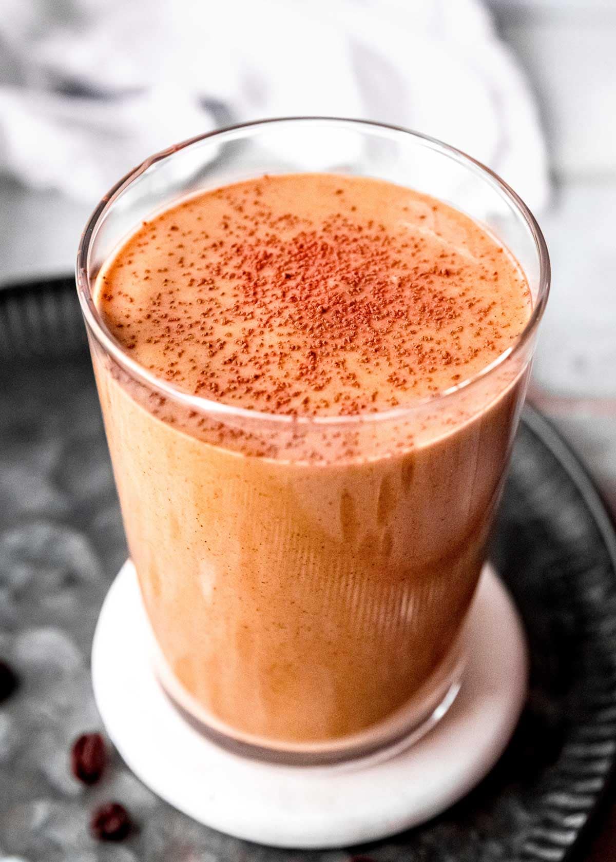 keto smoothie sprinkled with cocoa powder garnish