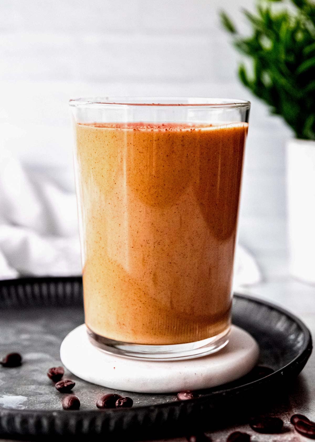 a straight shot of a peanut butter coffee smoothie in a glass