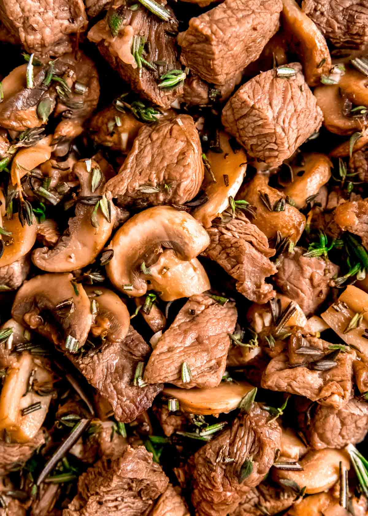 overhead closeup shot of steak and mushroom skillet