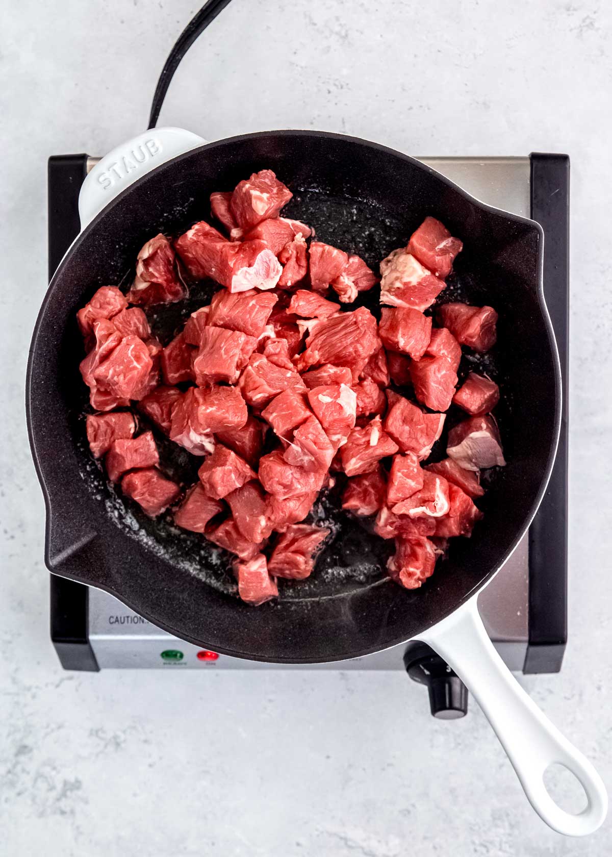 cubes of ribeye in a skillet