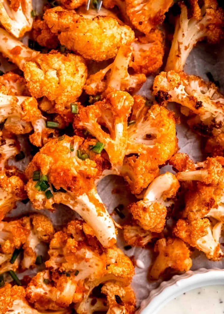 closeup overhead shot of buffalo cauliflower on a parchment paper covered pan