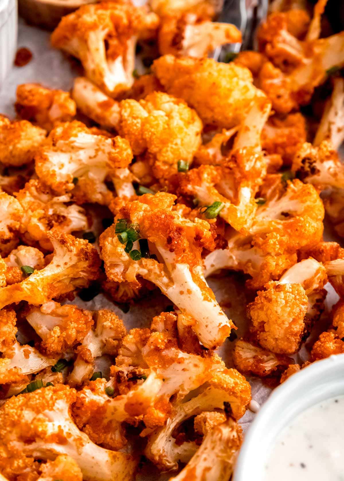 close up image of buffalo cauliflower on a sheet pan