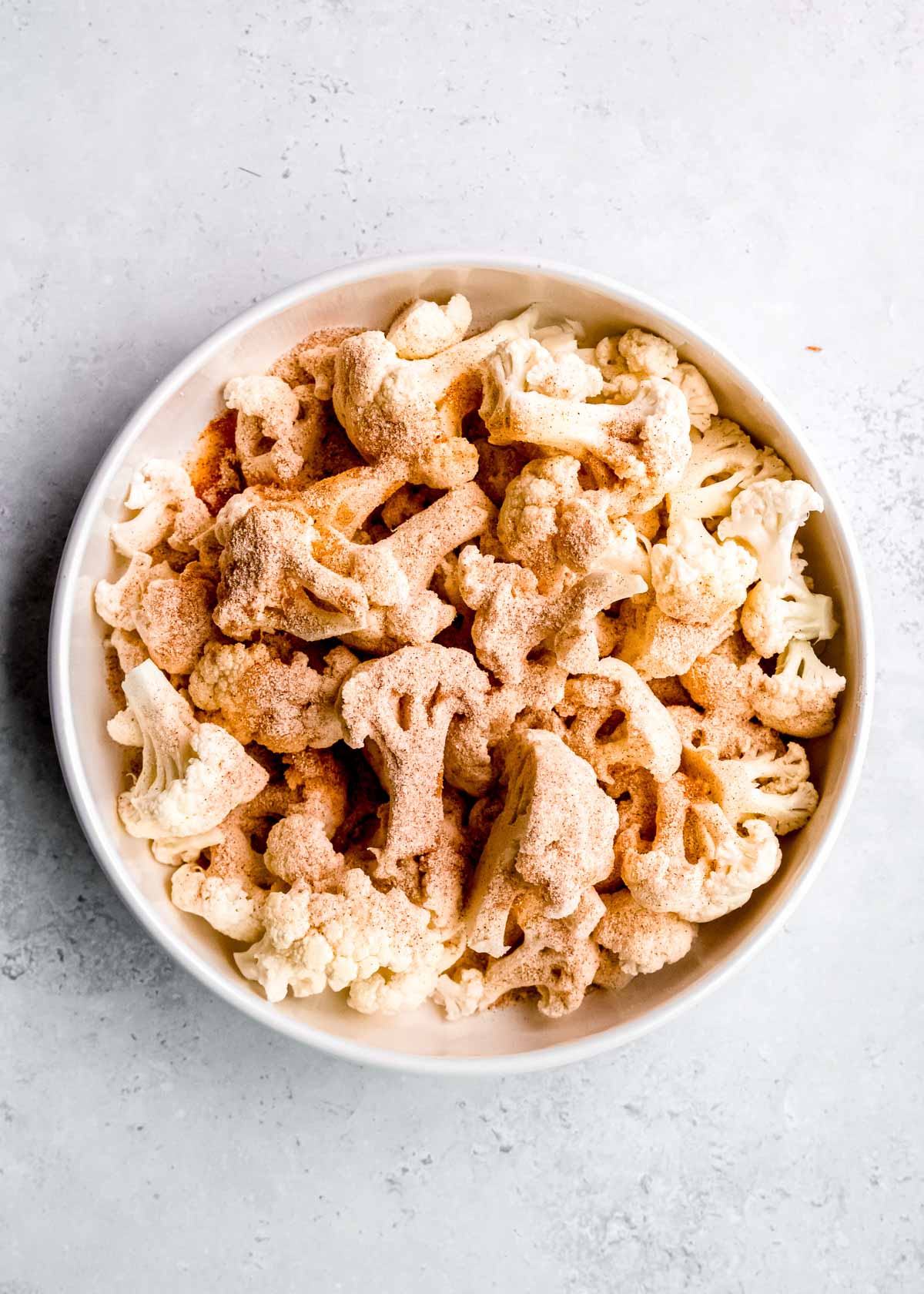 seasoned cauliflower in a white bowl