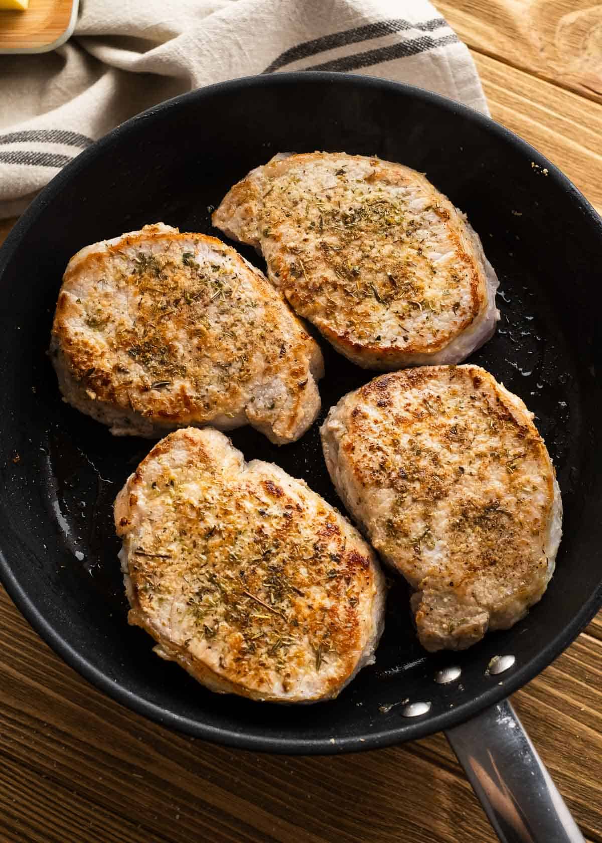 seared pork chops in a cast iron skillet