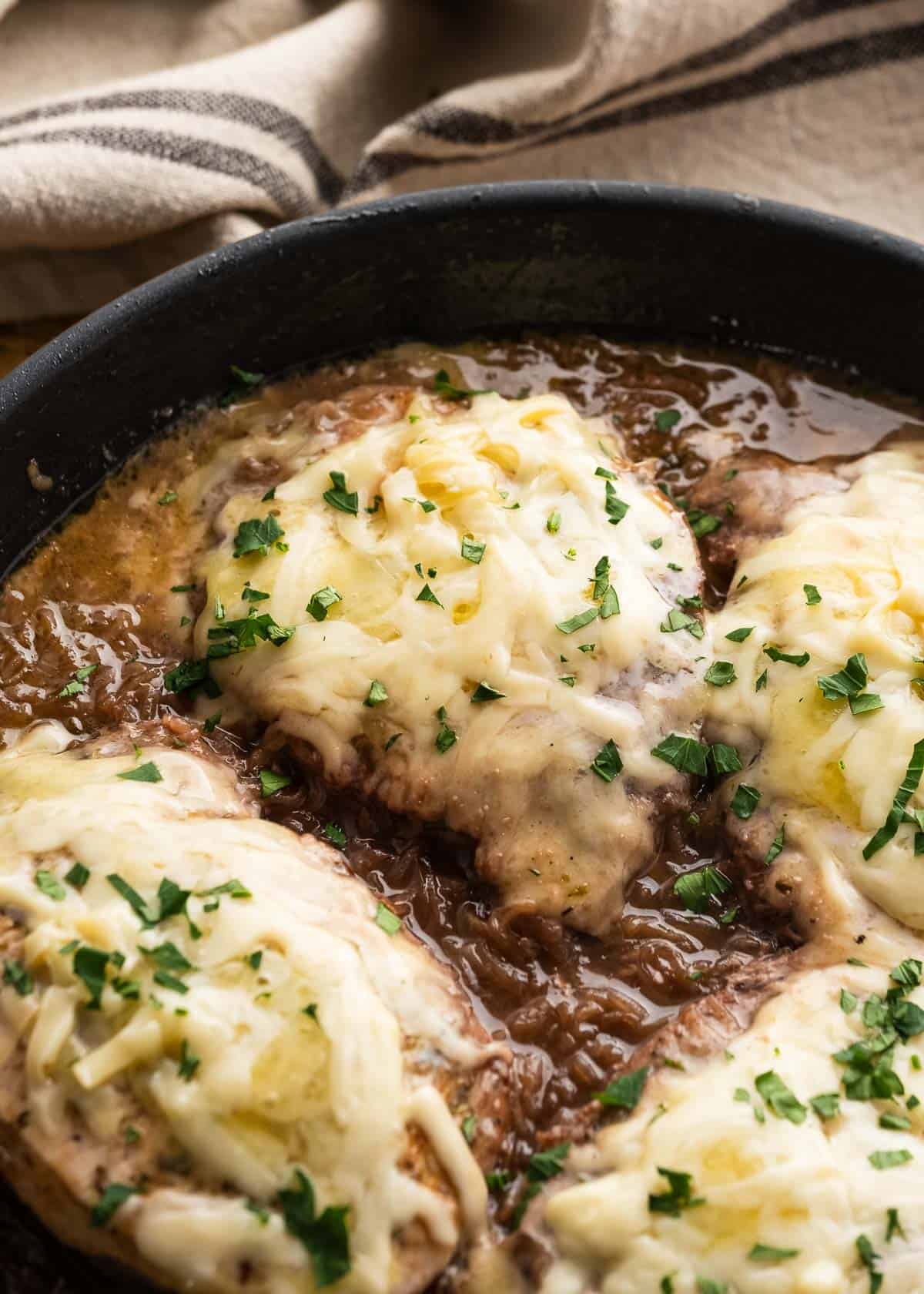 french onion pork chops in a cast iron skillet