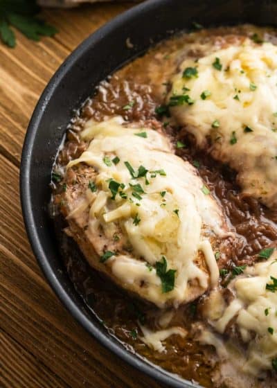 overhead shot of french onion pork chops in a cast iron skillet