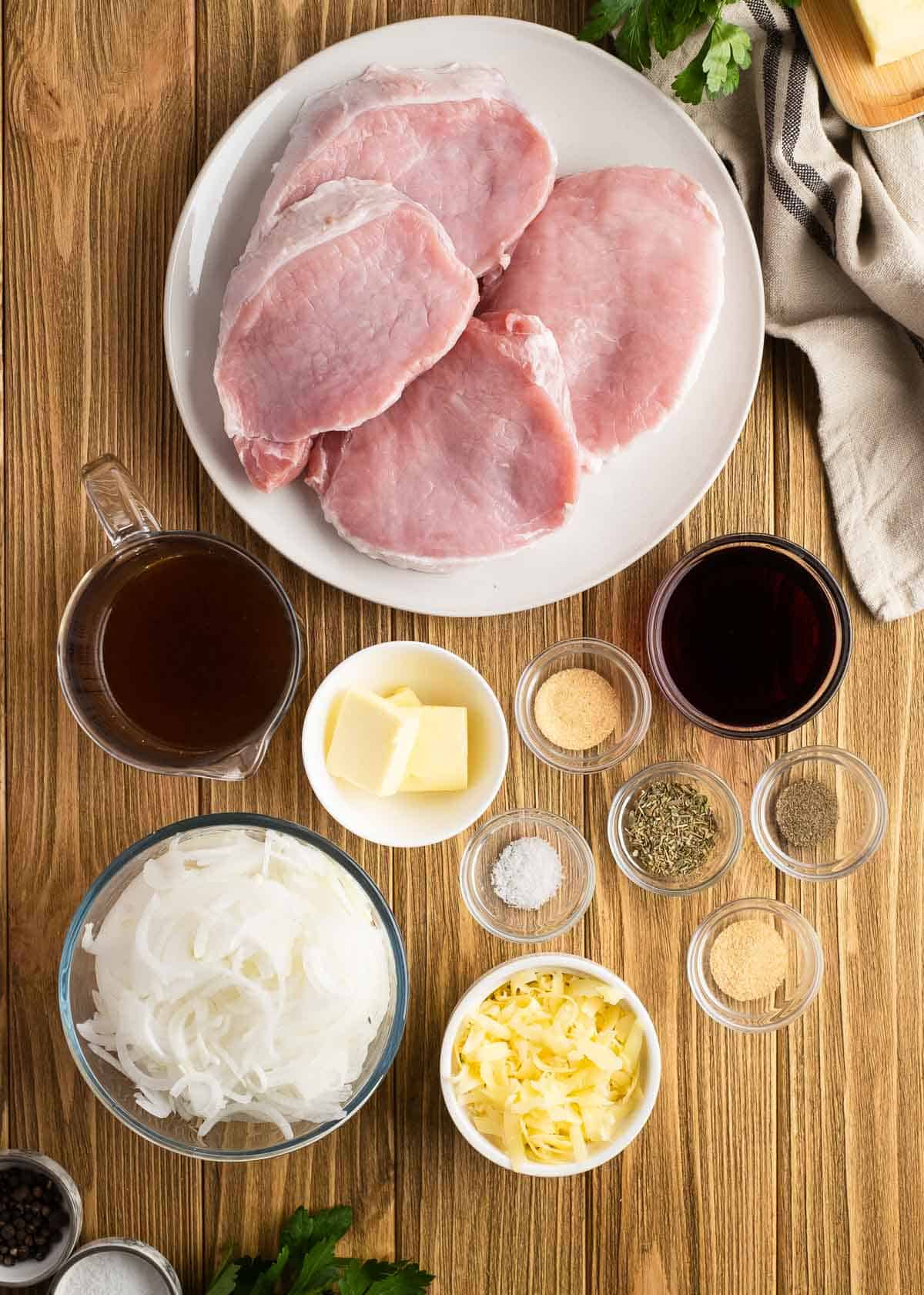 french onion pork chop ingredients on a wooden table