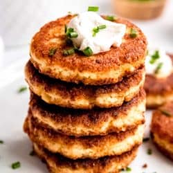 an overhead shot of cauliflower fritters with sour cream and chives