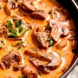 a bowl of mushroom soup with steak