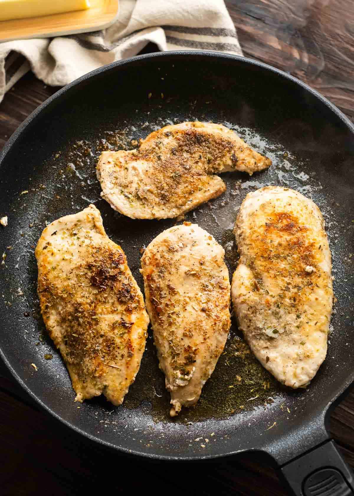 browned chicken in a cast iron skillet