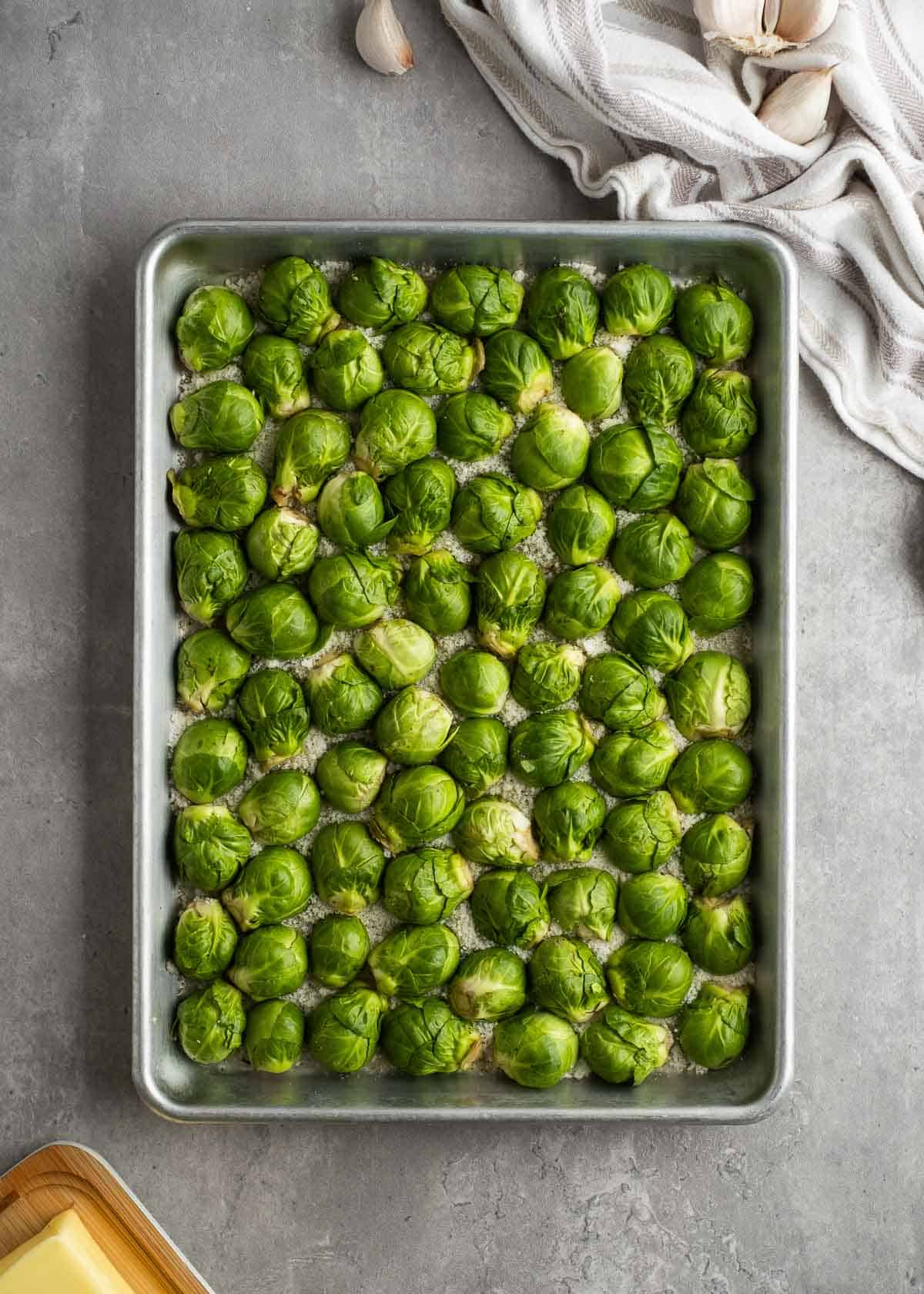 overhead image of uncooked brussels sprouts on a sheet pan