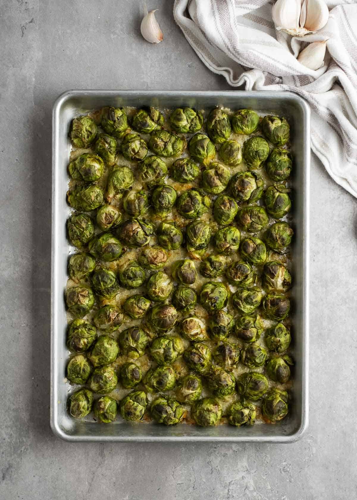 overhead image of cooked brussels sprouts on a sheet pan