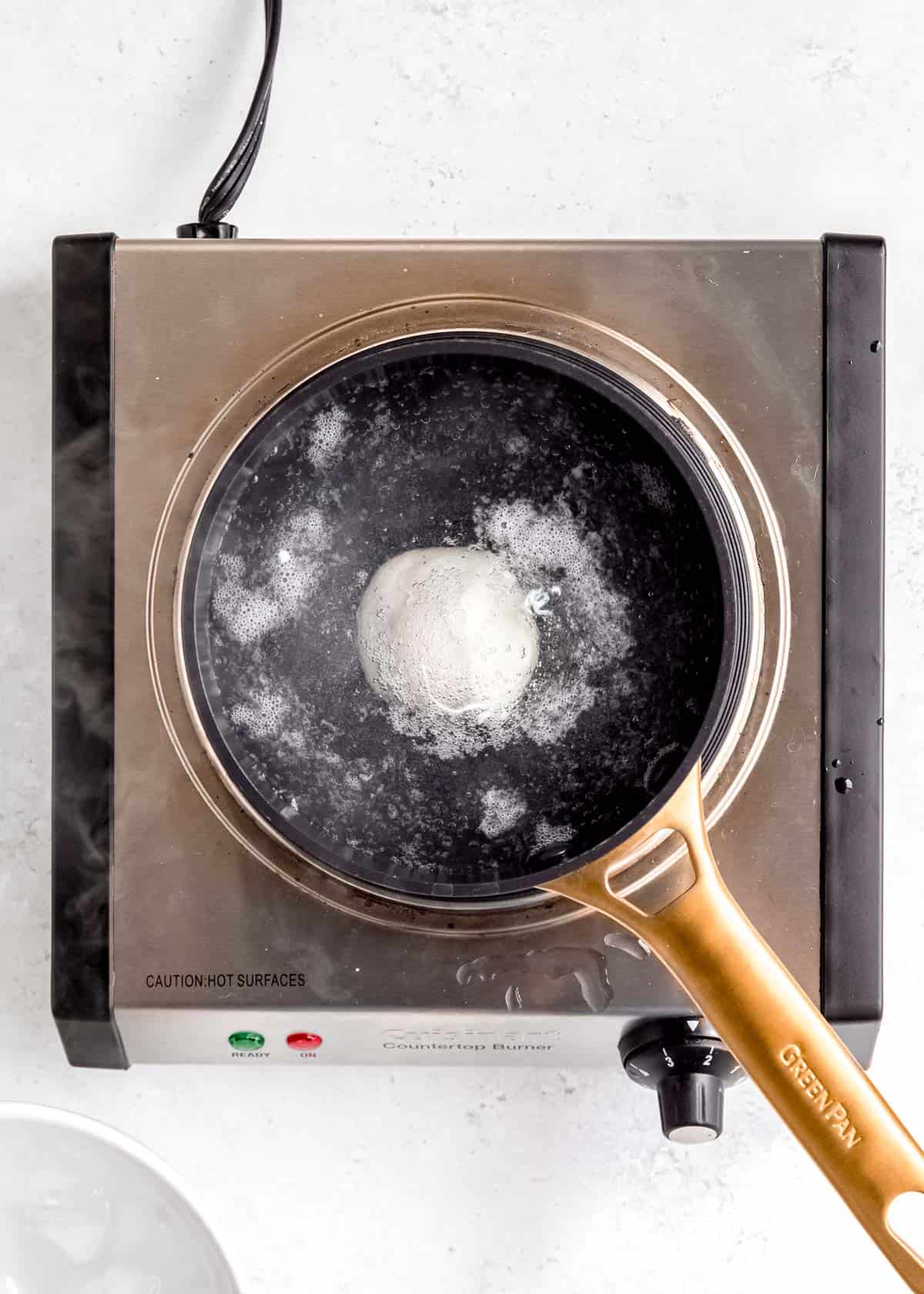overhead image of egg being poached