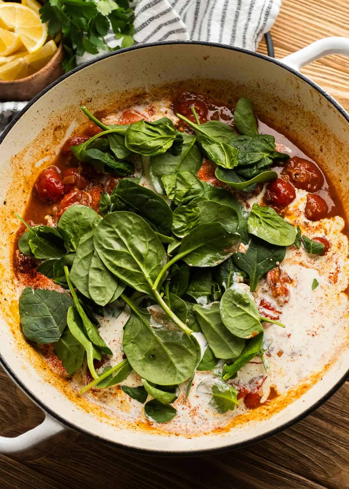 spinach being added to pan