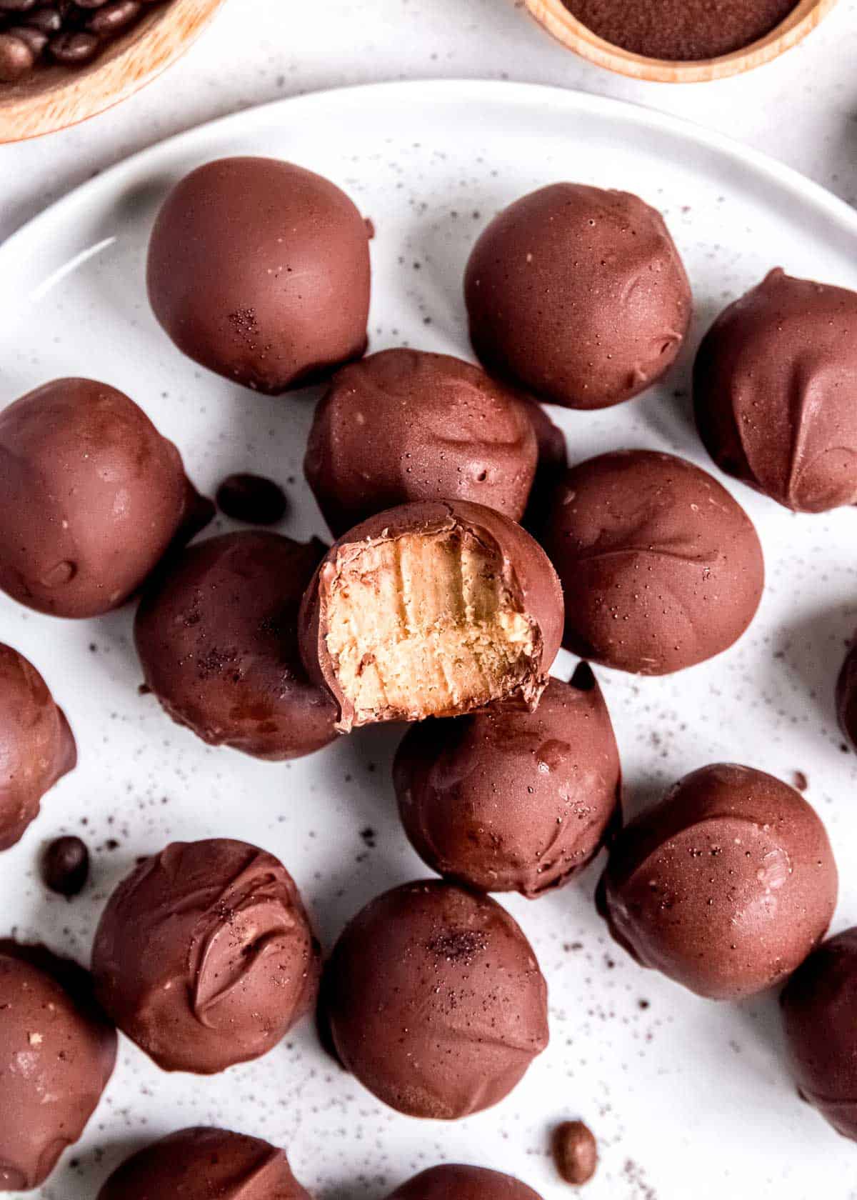 close up image of espresso truffles with single truffle on top with a bite removed