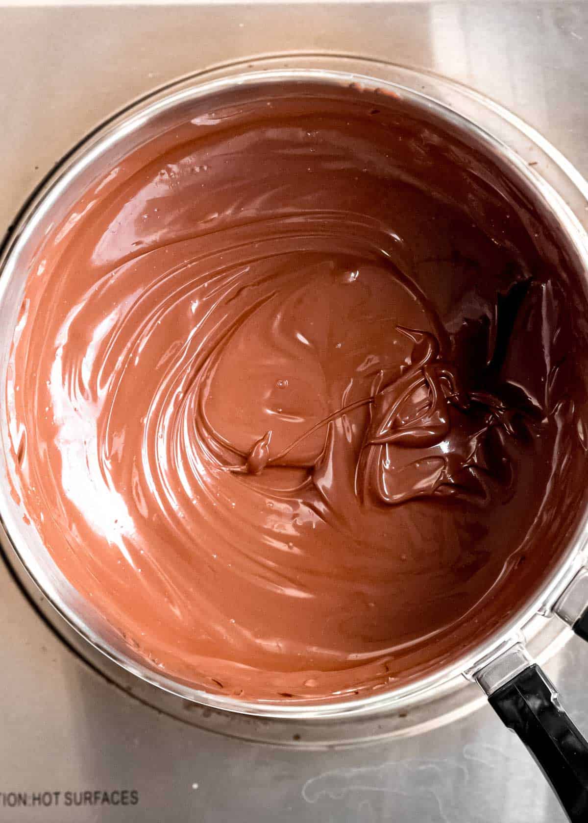 overhead image of chocolate truffle coating ingredients melted in a pot