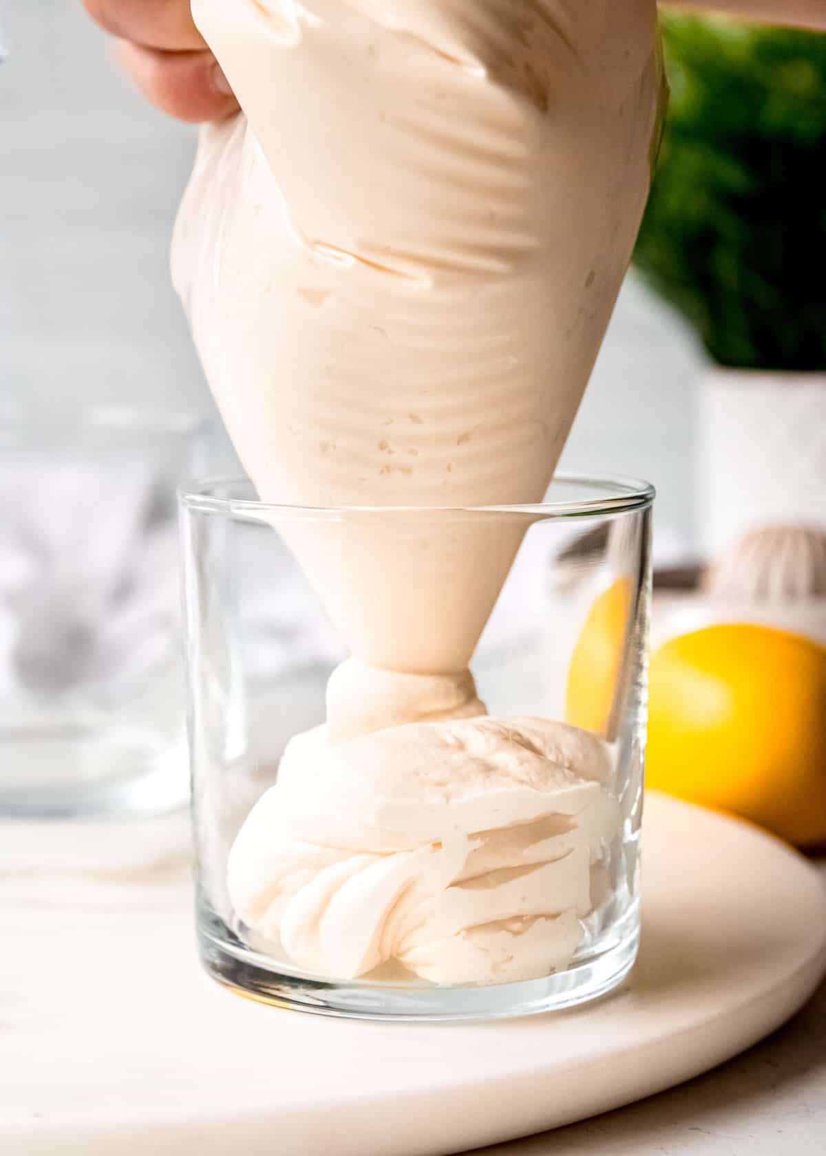 lemon mousse being added to individual containers