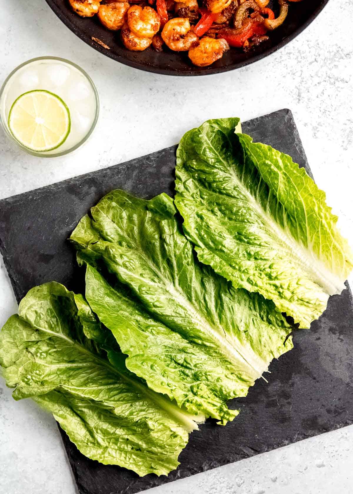 lettuce on a black cutting board