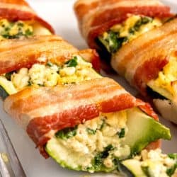 close up image of bacon wrapped zucchini with slice missing