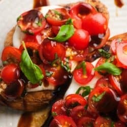 close up image of bruschetta chicken on a white plate
