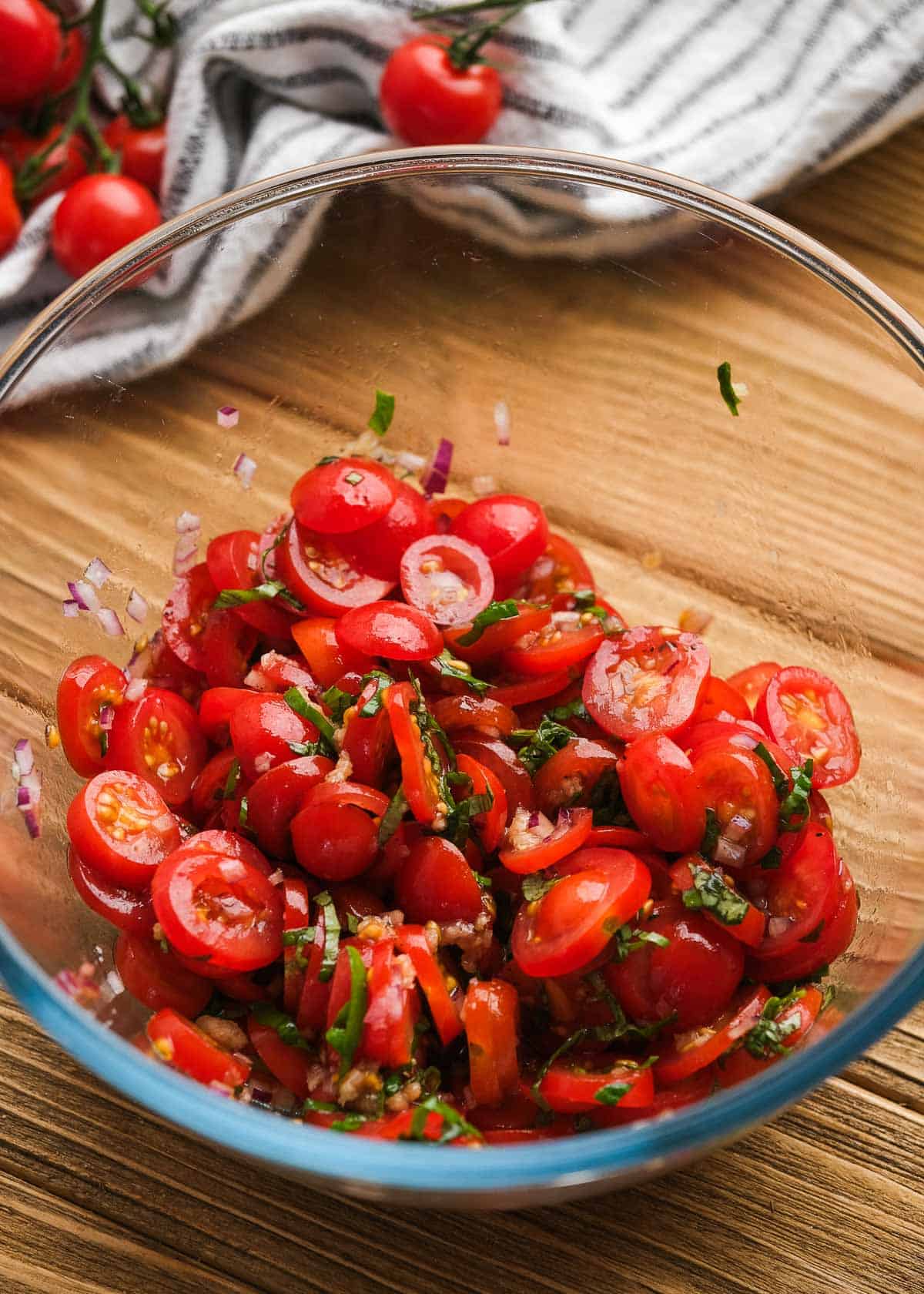 bruschetta in a clear mixing bowl