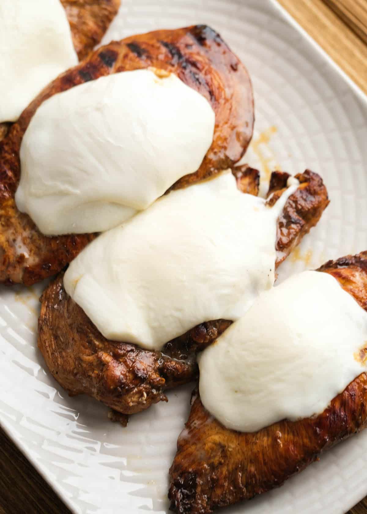 grilled bruschetta chicken after adding slice of mozzarella