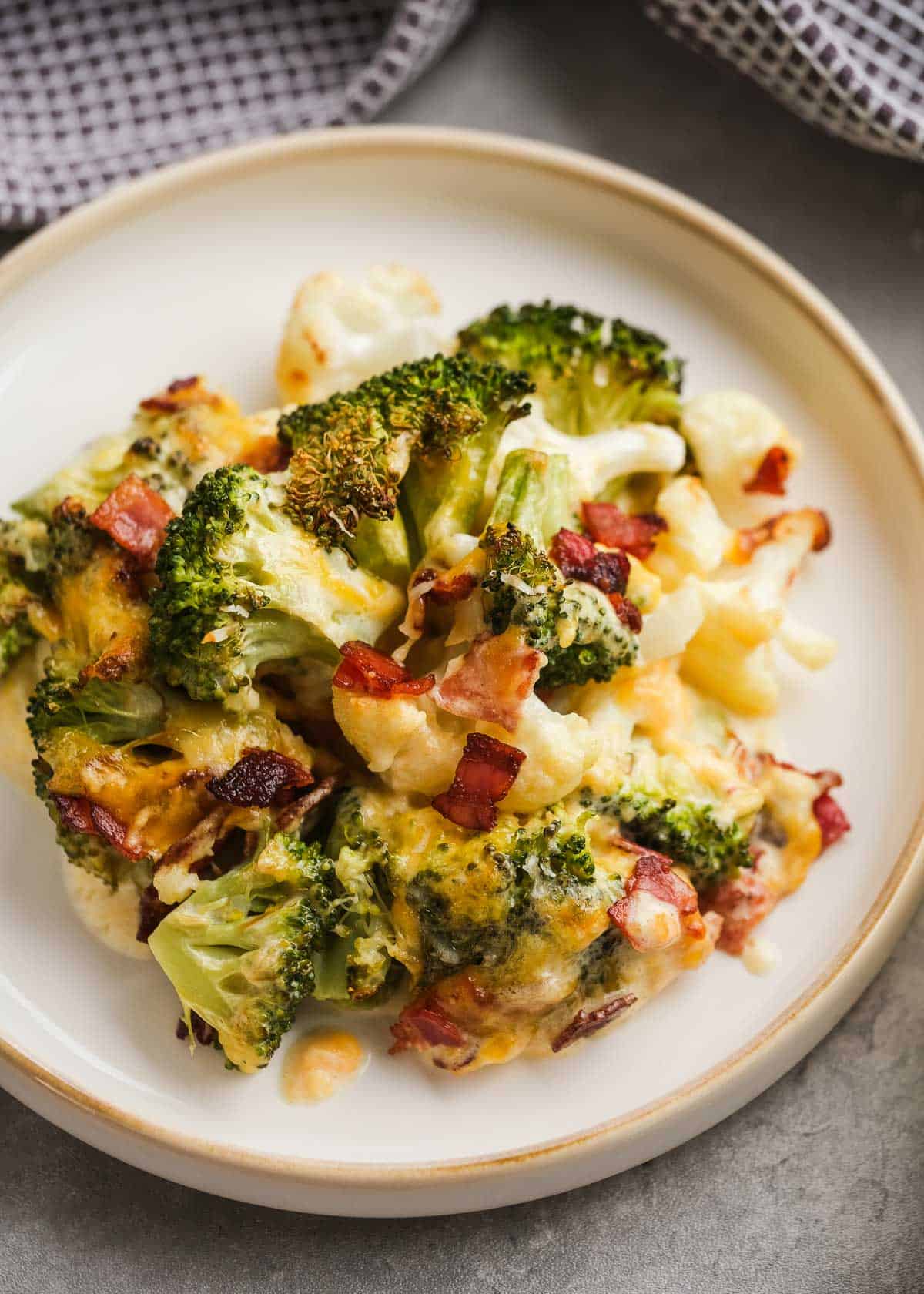 a white plate topped with broccoli cauliflower casserole