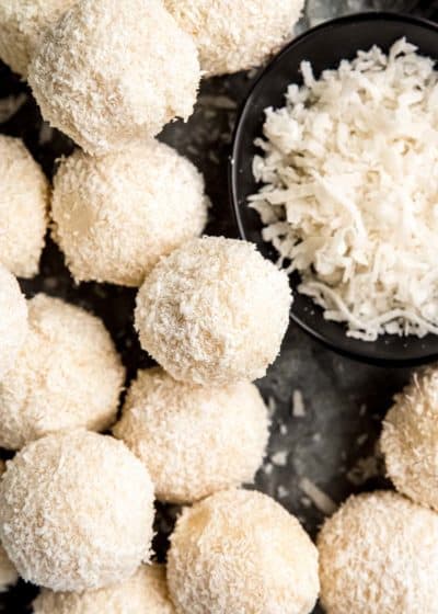 overhead image of coconut truffles on a black plate