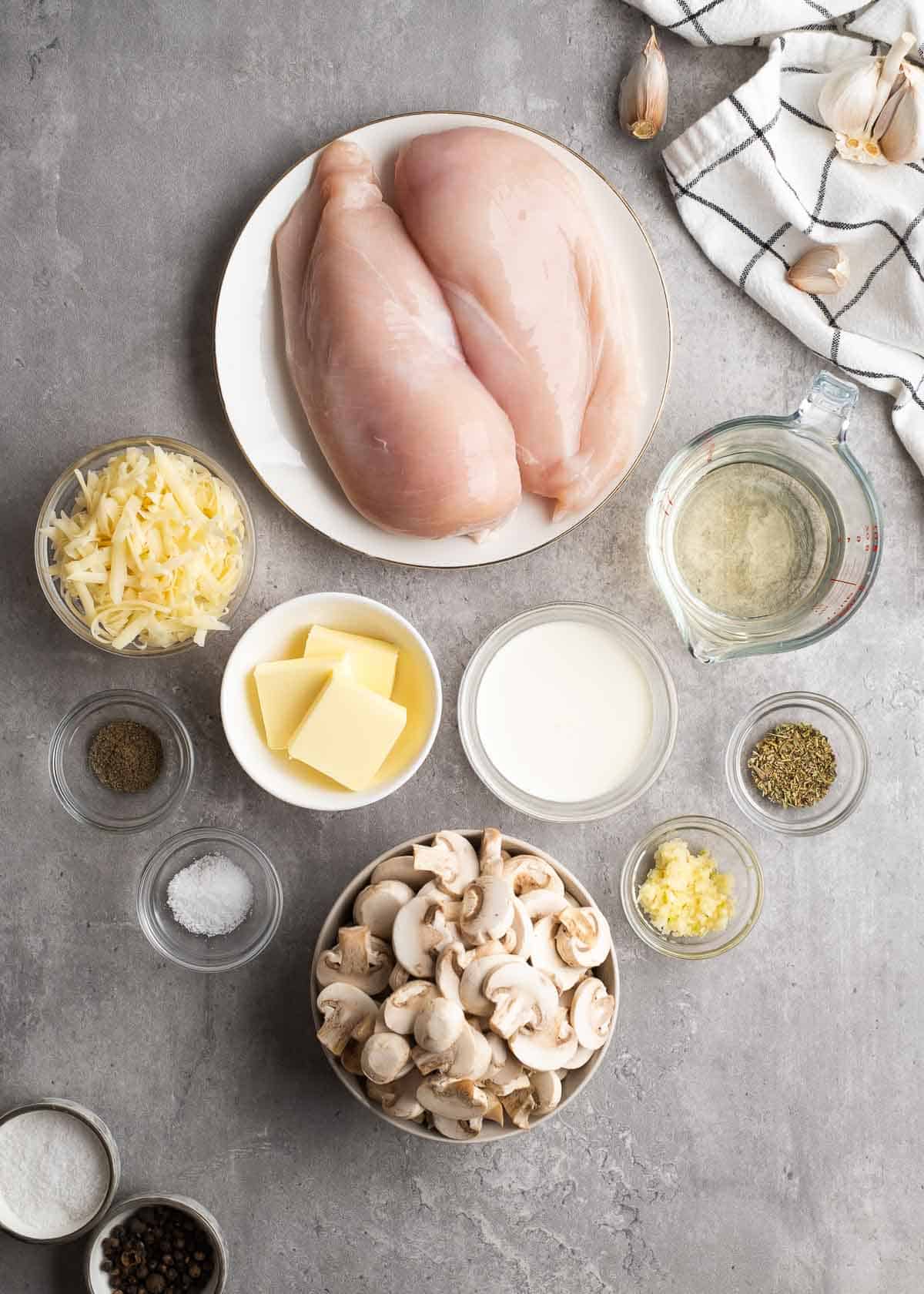 overhead image of creamy mushroom chicken ingredients on gray background