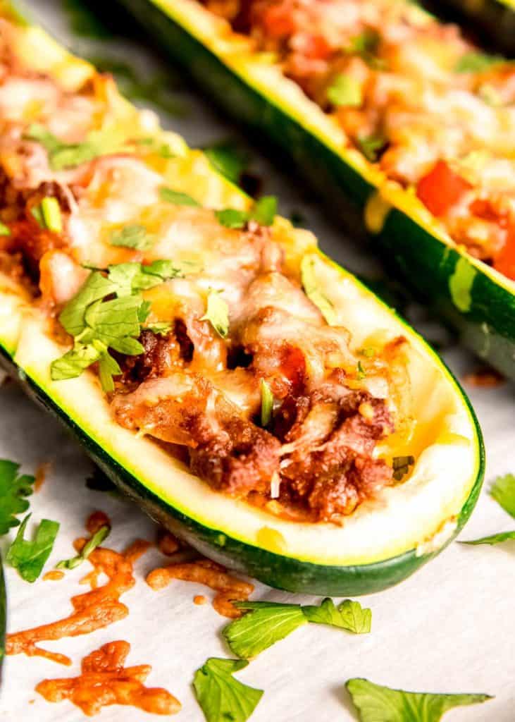 closeup view of hollow zucchini boat stuffed full with beef enchilada mixture