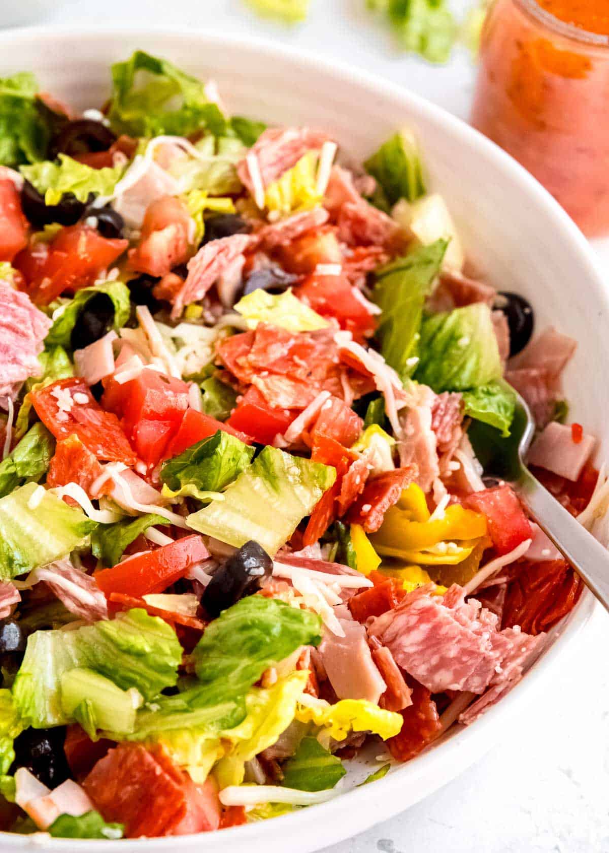 close up image of italian sub in a tub in a white bowl